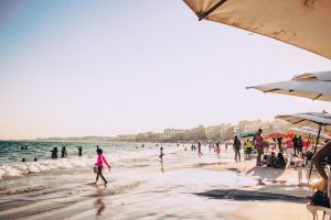 A beach full of people in one of the best cities in Brazil for expats